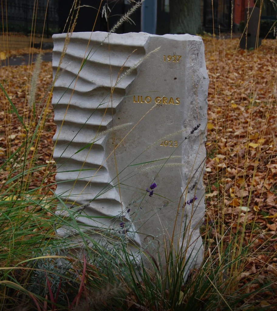 Grabstein aus Jura-Kalkstein mit geschwungener Teilung, polierter Fläche und Wellenstruktur