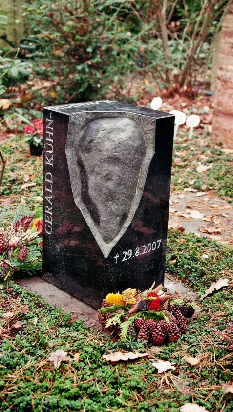 Grabstein aus poliertem Granit mit hervorbrechendem Findlingselement